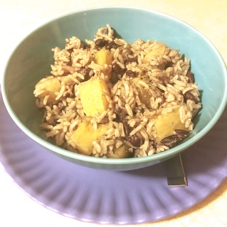 Bowl of black beans and pineapple and rice
